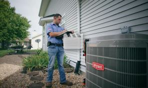 Man doing maintenance on a Bryant air conditoiner